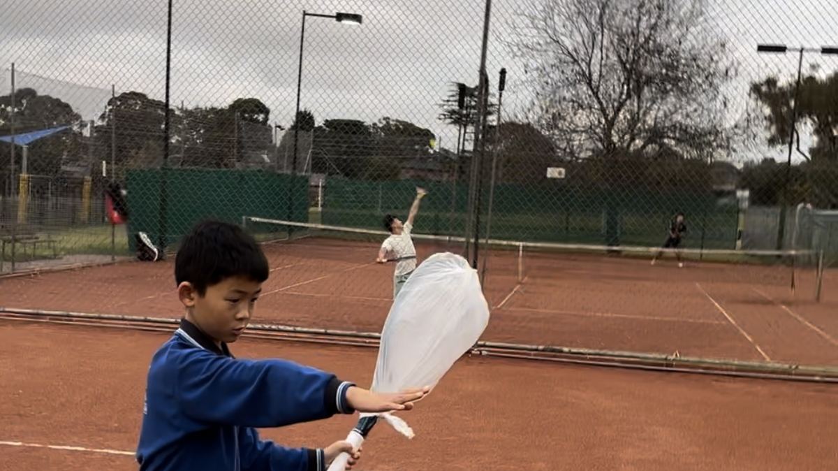 Junior players rallying during an intermediate tennis class in Vermont South, Melbourne